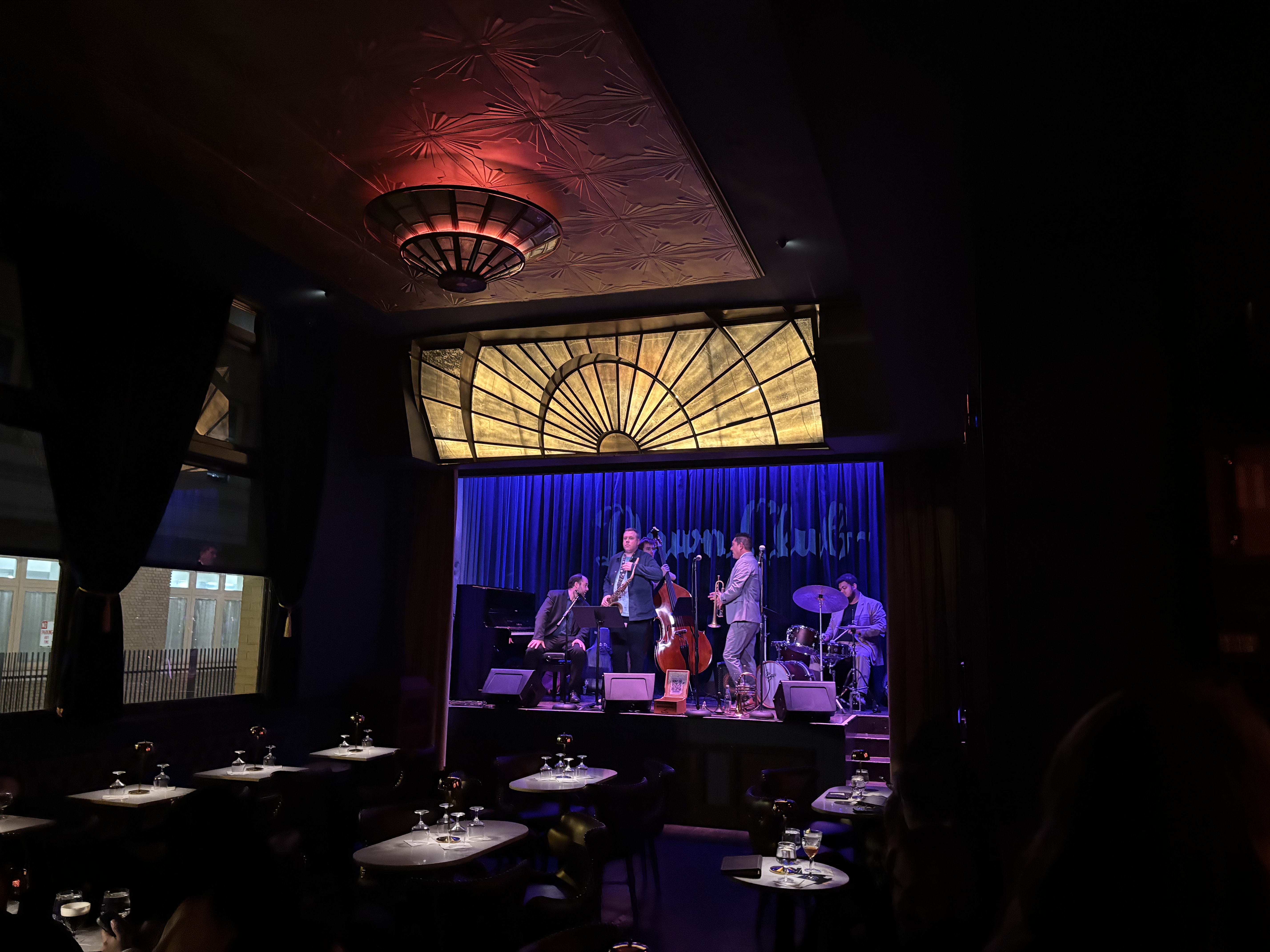 Jazz quintet on stage beneath an art deco sunburst, Dawn Club, San Francisco